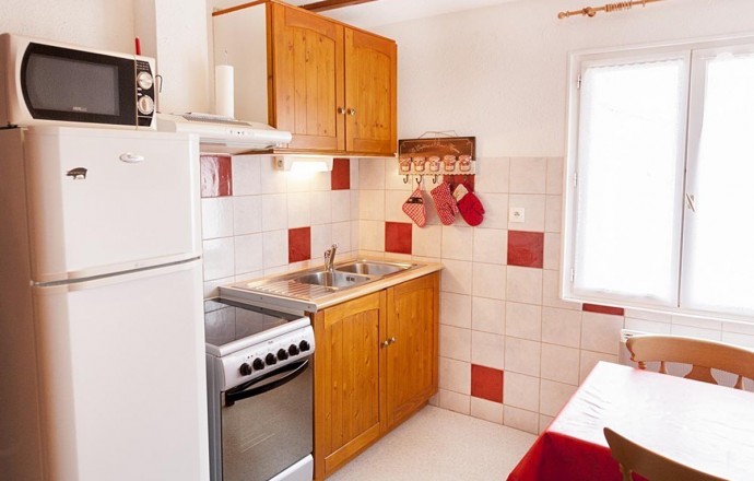 Kitchen equipped with refrigerator freezer, microwave, stove, lava-linen and the whole dishes to cook
